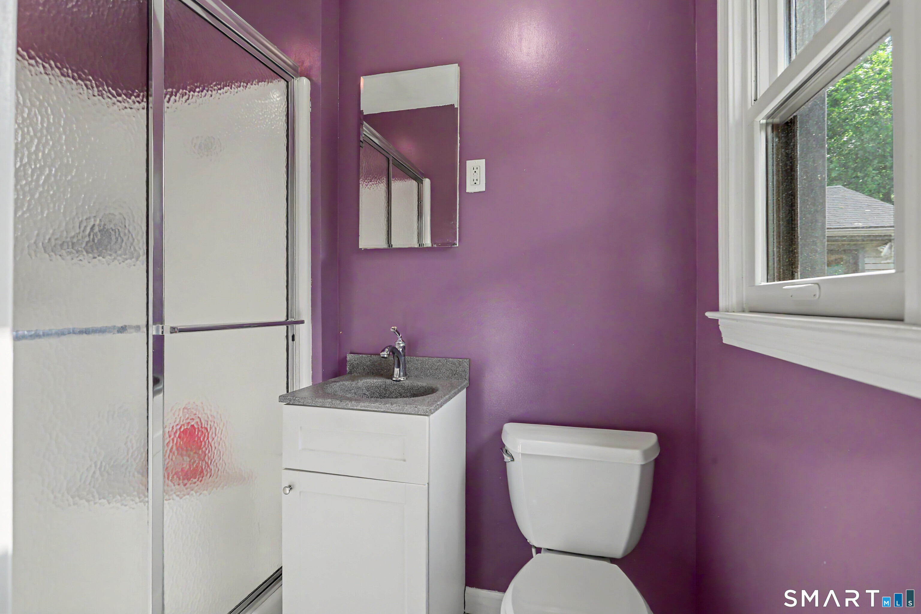 632 Wheelers Farm Road Orange, CT 06477 - Photo 19 of 39 a bathroom with a toilet sink and mirror