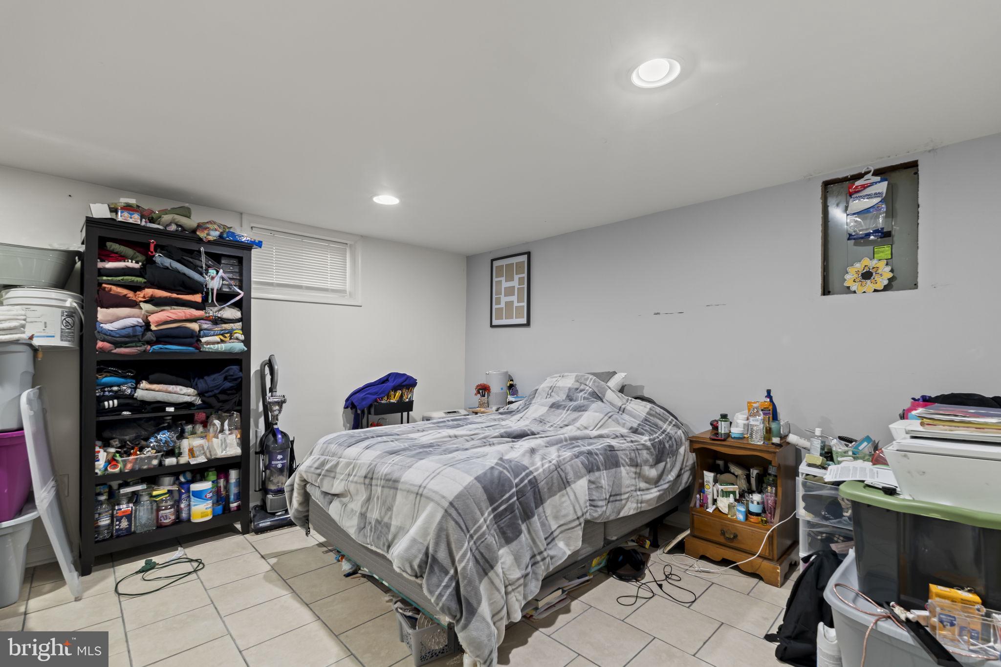3105 Newportville Road Bristol, PA 19007 - Photo 21 of 30 a bedroom with a bed and a bookshelf