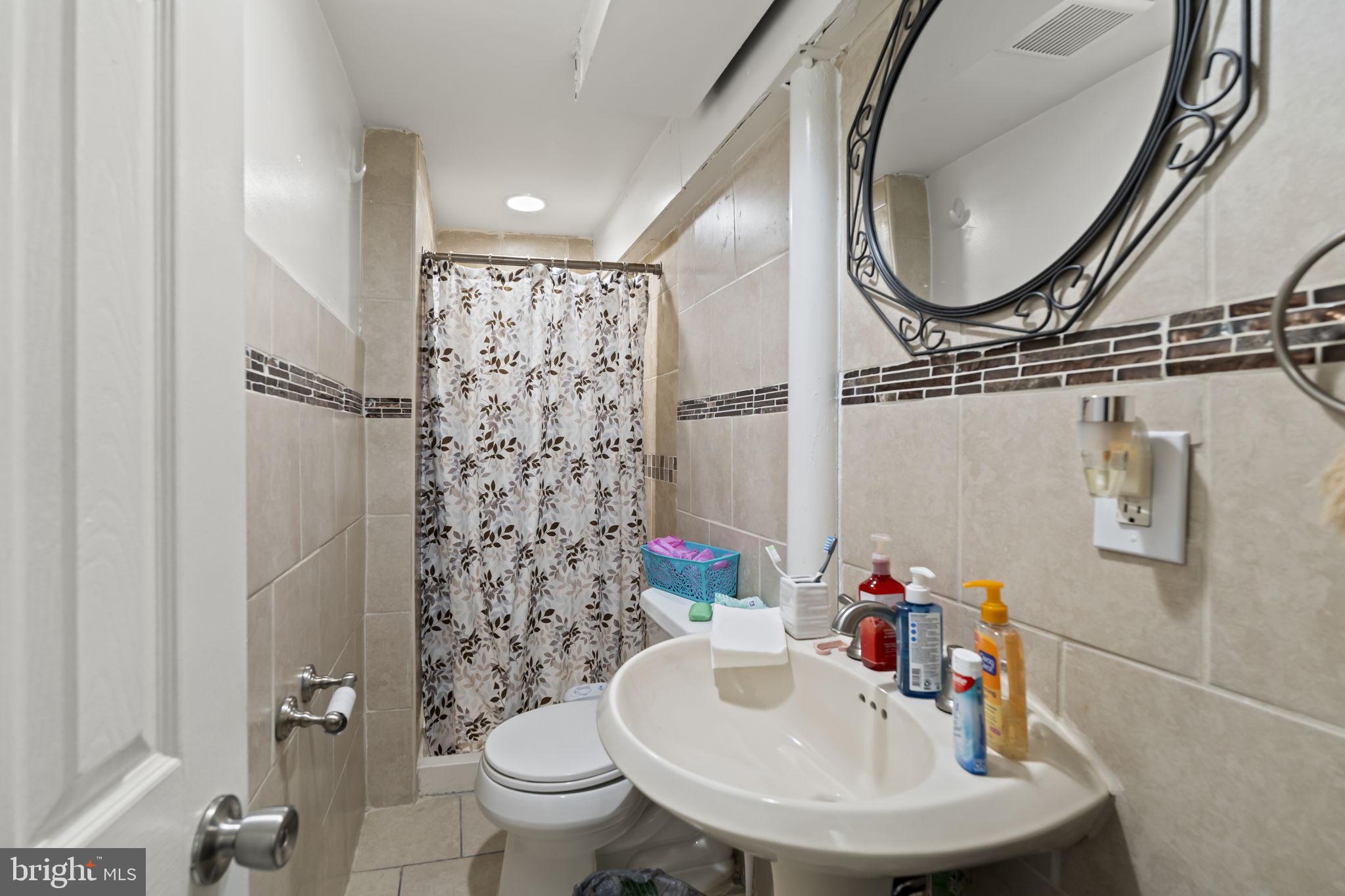 3105 Newportville Road Bristol, PA 19007 - Photo 23 of 30 a bathroom with a sink toilet and a mirror