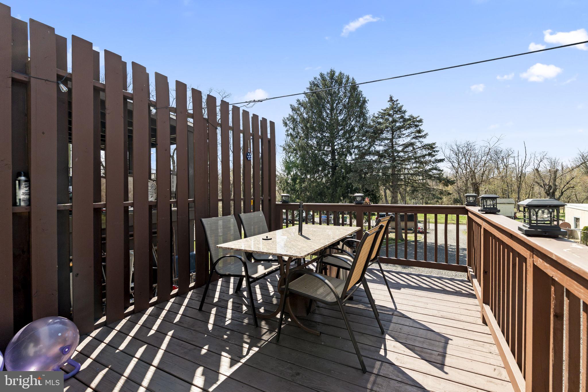 3105 Newportville Road Bristol, PA 19007 - Photo 29 of 30 a balcony with wooden floor table and chairs
