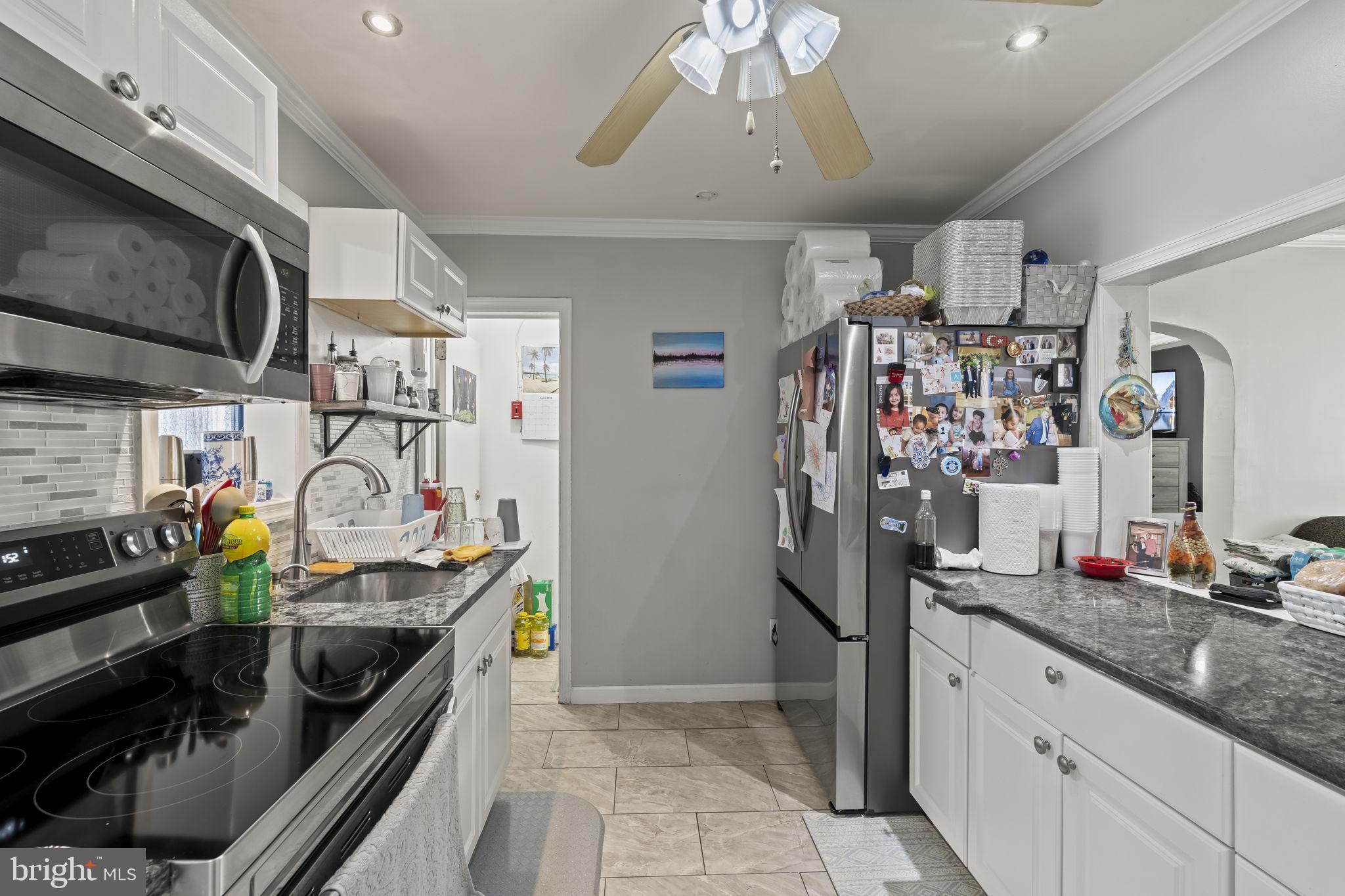3105 Newportville Road Bristol, PA 19007 - Photo 6 of 30 a kitchen with stainless steel appliances granite countertop a sink and cabinets