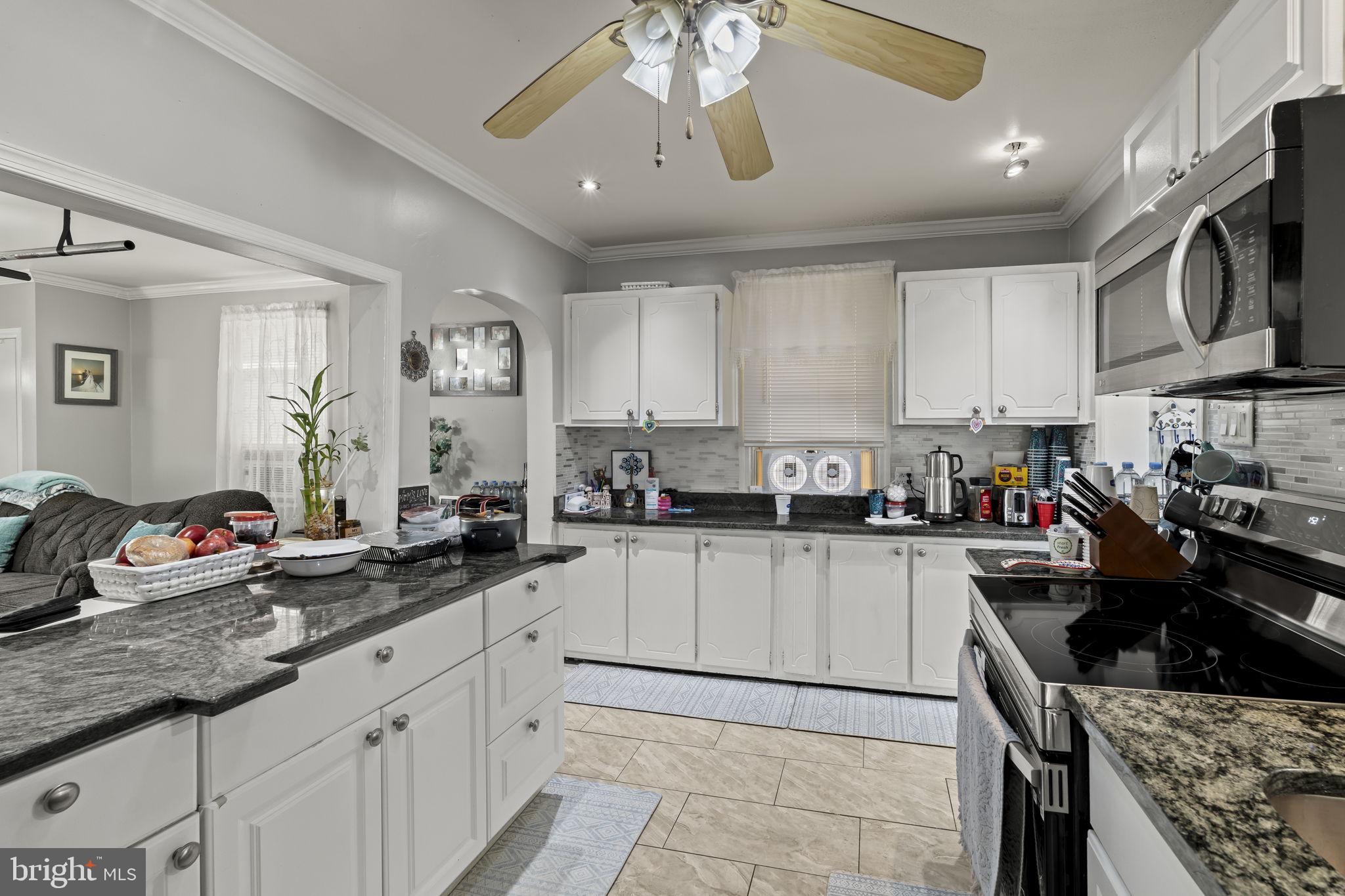 3105 Newportville Road Bristol, PA 19007 - Photo 7 of 30 a kitchen with stainless steel appliances a sink stove and cabinets