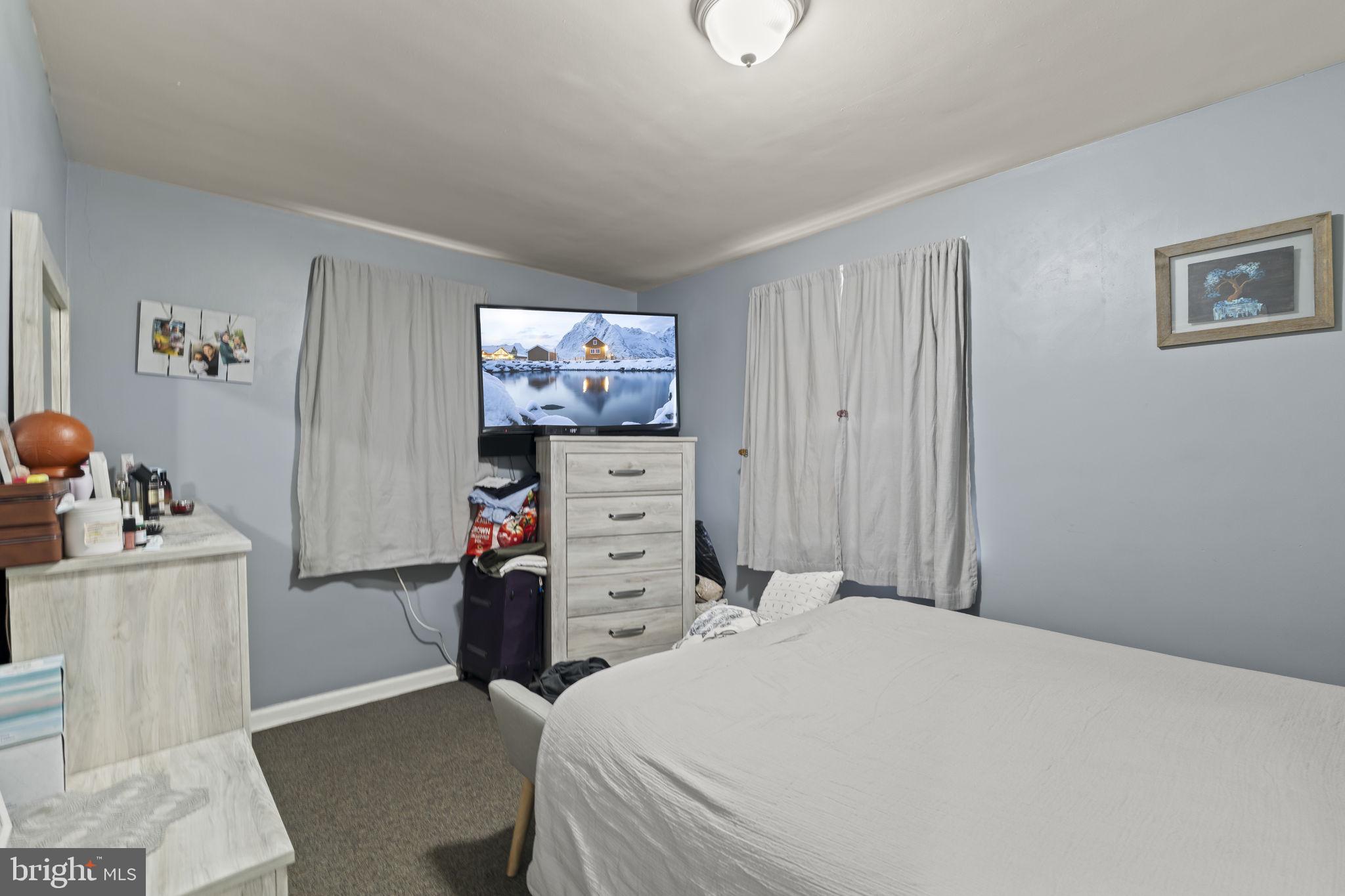 3105 Newportville Road Bristol, PA 19007 - Photo 8 of 30 a bedroom with a bed and a flat screen tv