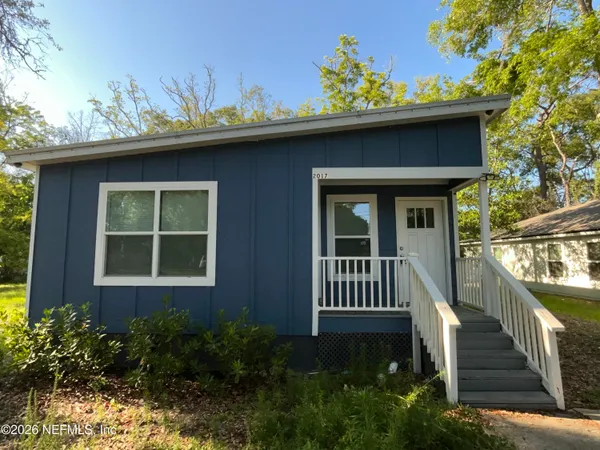 a view of a house with a small yard