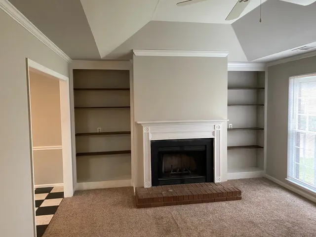 a living room with furniture and a fireplace