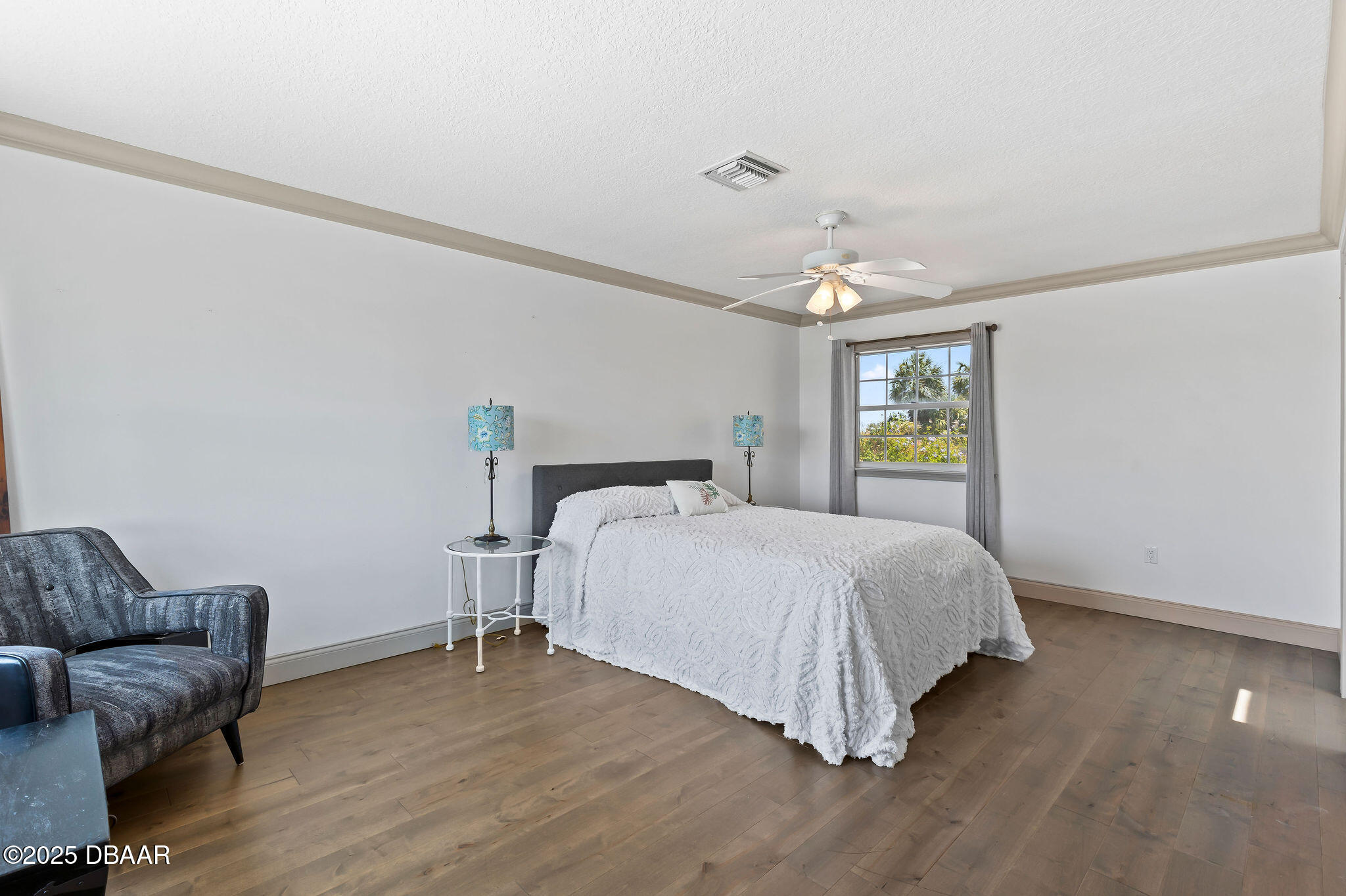 604 Springdale Drive Flagler Beach, FL 32136 - Photo 39 of 78 a spacious bedroom with a bed and a couch