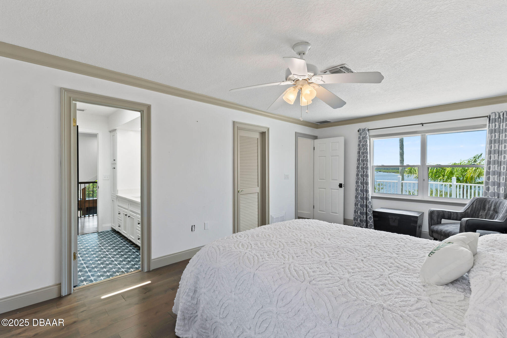604 Springdale Drive Flagler Beach, FL 32136 - Photo 40 of 78 a bedroom with a large bed and a chandelier