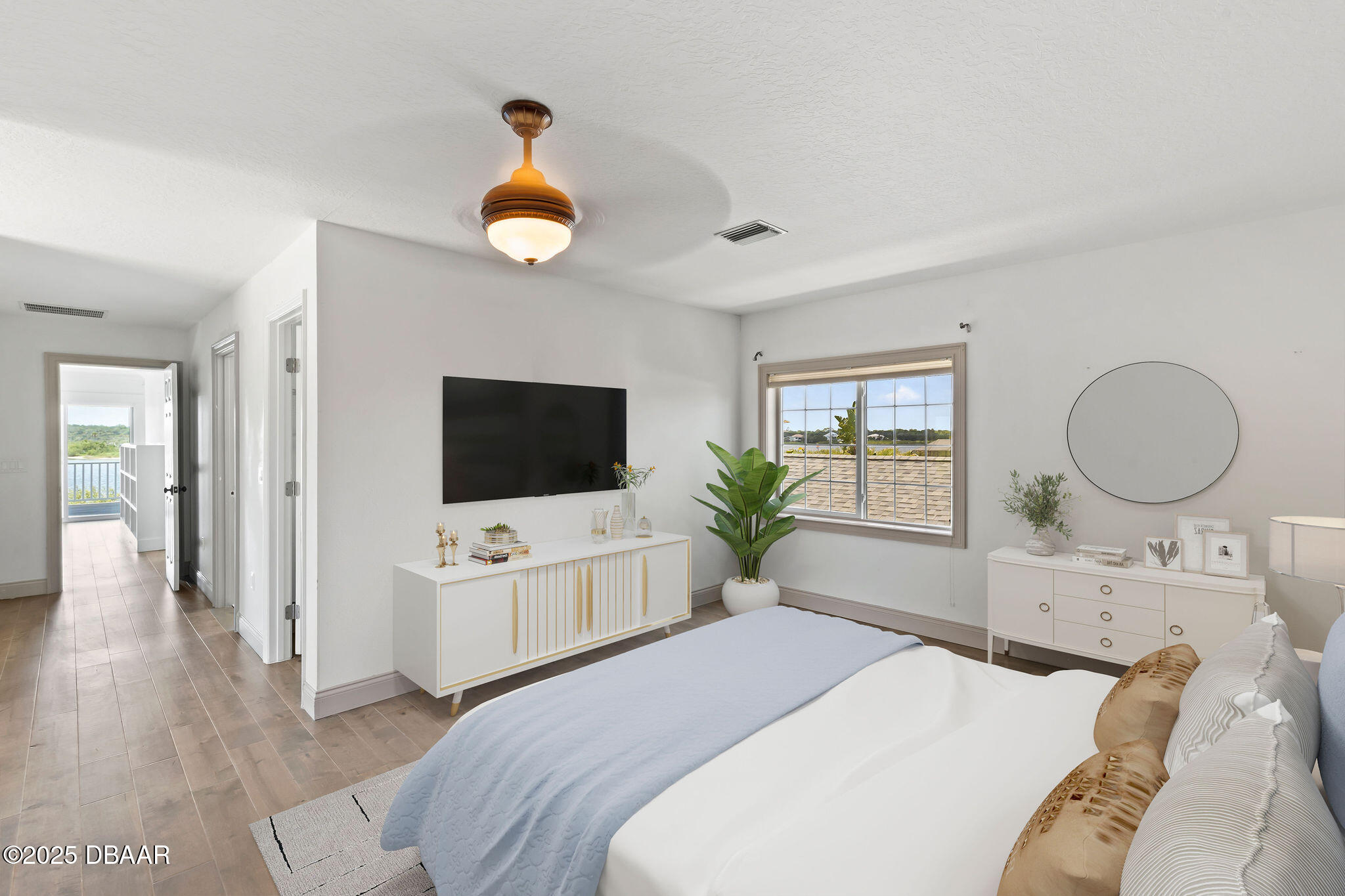 604 Springdale Drive Flagler Beach, FL 32136 - Photo 51 of 78 a bedroom with a bed a dresser and a flat screen tv