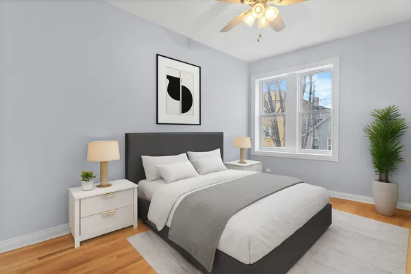 a bedroom with a bed and a potted plant