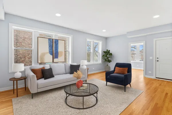 a living room with furniture and a wooden floor