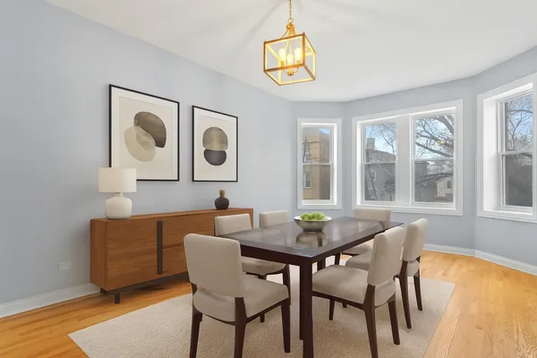 a view of a dining room with furniture and chandelier