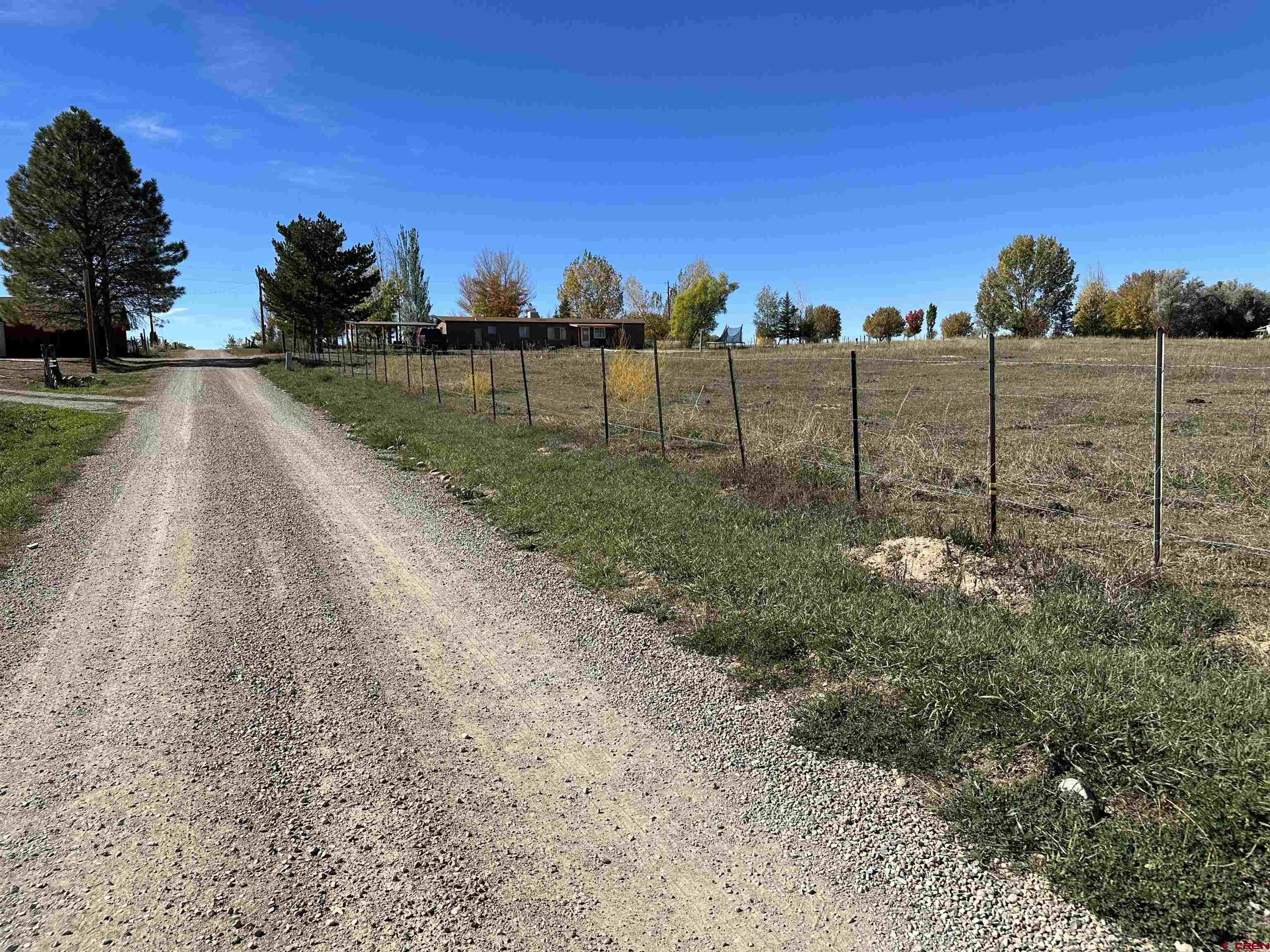 24807 Rd M.3 Cortez, CO 81321 - Photo 1 of 1 a view of a lake with a house in the background