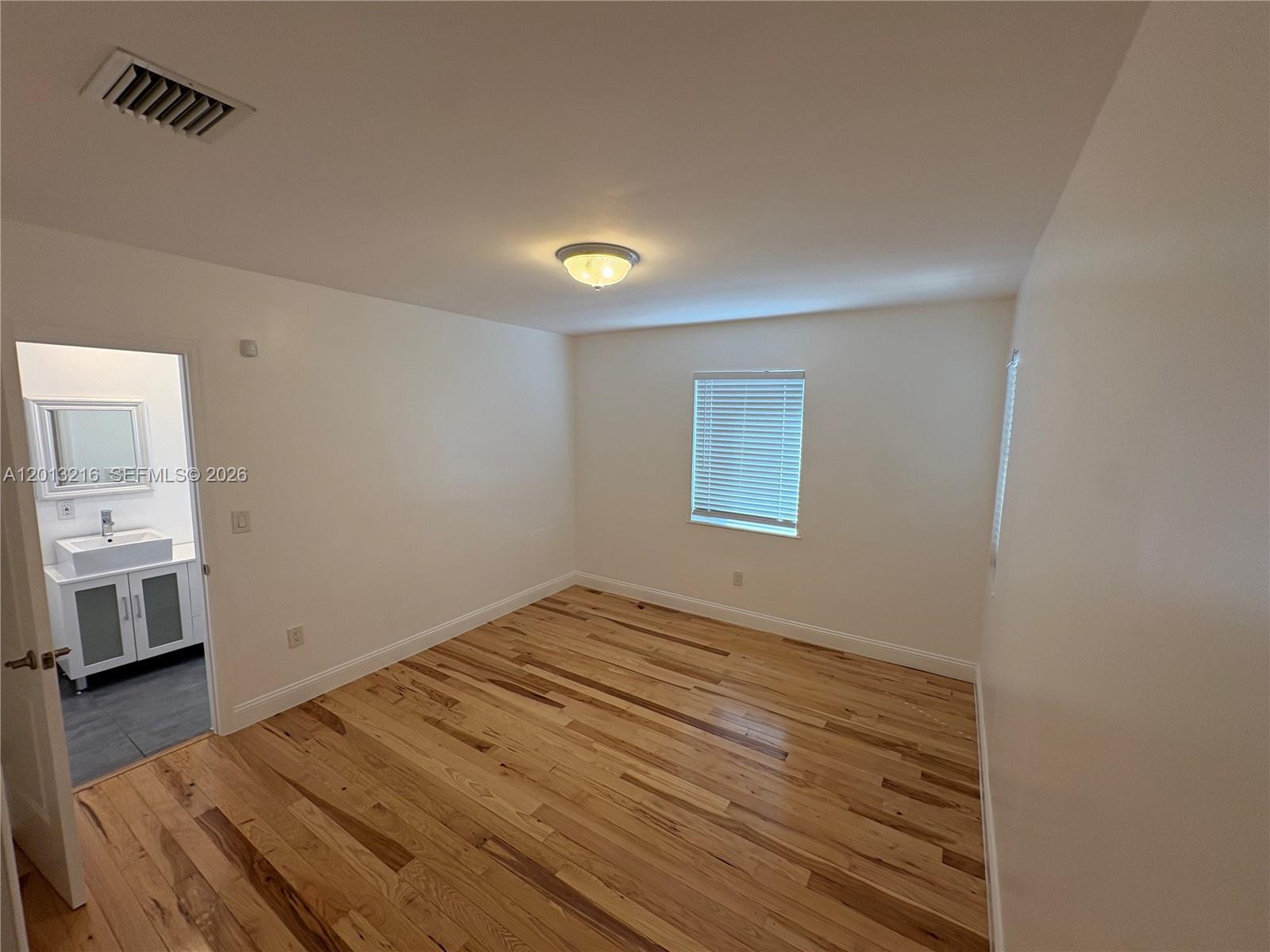 250 Southwest 19th Road Miami, FL 33129 - Photo 8 of 22 a view of empty room with wooden floor and window