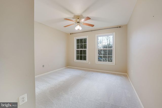 a view of an empty room with a ceiling fan