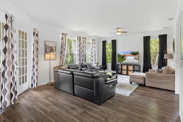 a living room with furniture and large windows