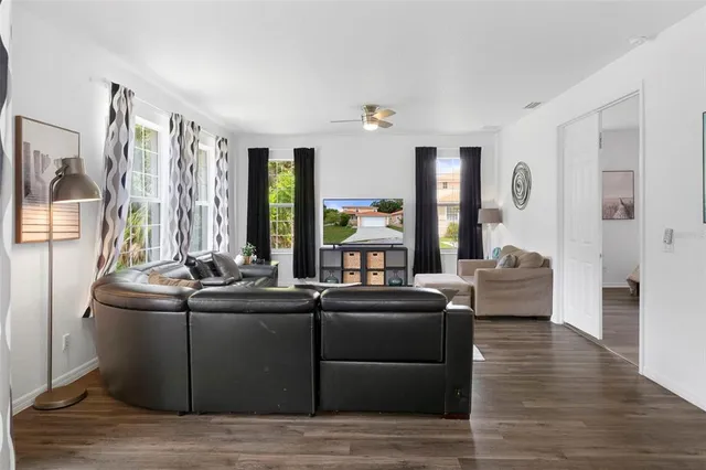 a living room with furniture window and wooden floor