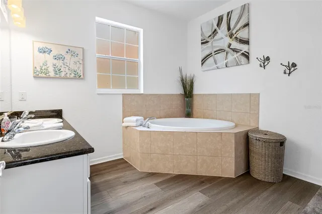 a bathroom with a bathtub and a window