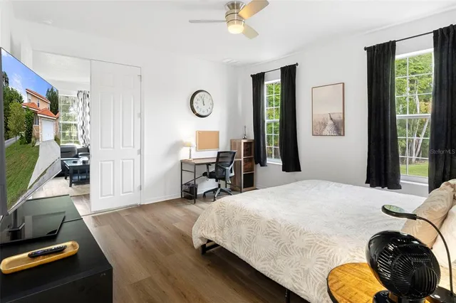 a bed room with a bed mirror and a window