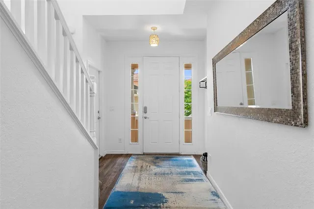 a view of an entryway with wooden floor