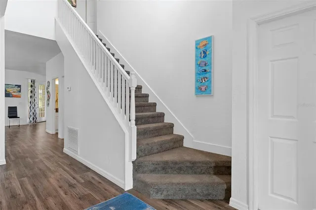 a view of entryway and hall with wooden floor