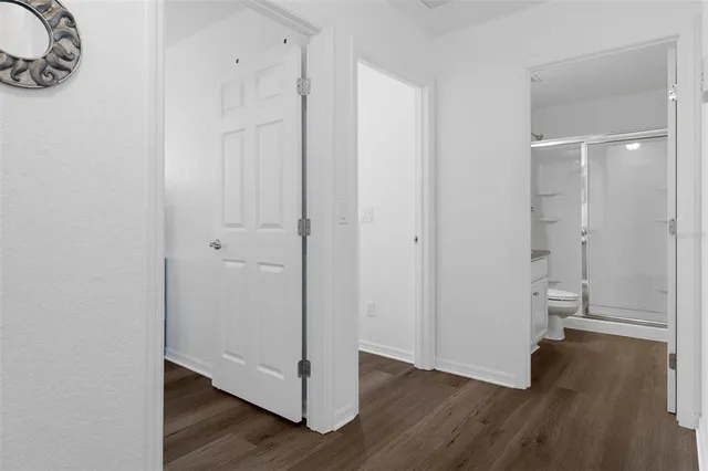 a view of a room with wooden floor