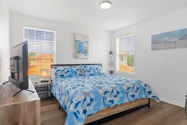 a bedroom with a large bed and a window