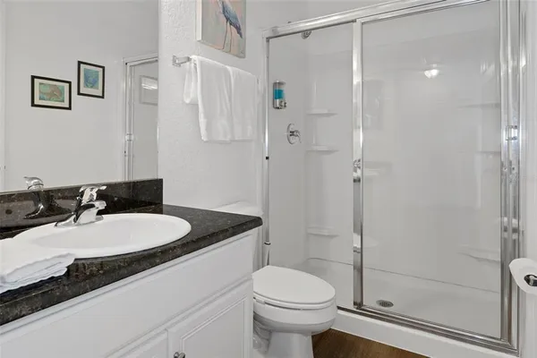 a bathroom with a sink toilet and shower