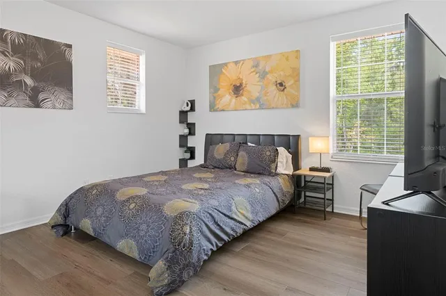 a bed sitting in a bedroom next to a window