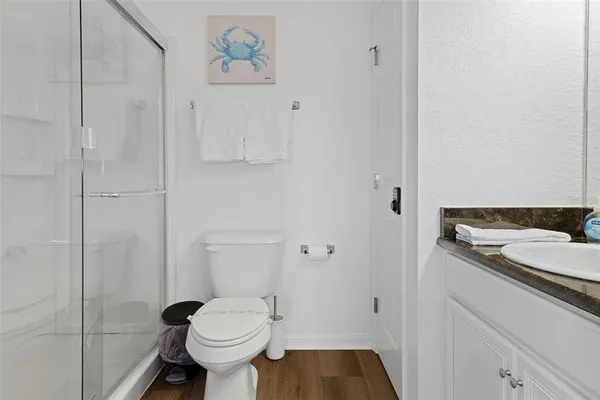 a bathroom with a sink toilet and a mirror