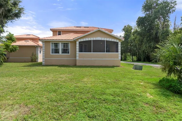 a front view of house with yard and green space