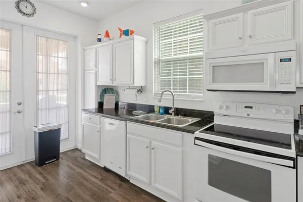 a kitchen with appliances cabinets and a sink