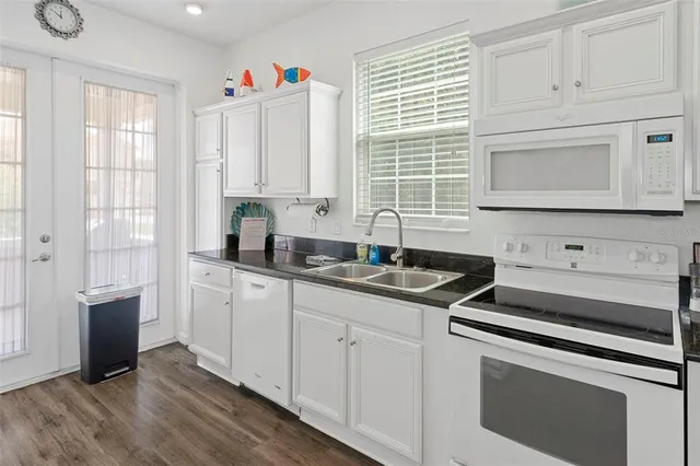 a kitchen with appliances cabinets and a sink