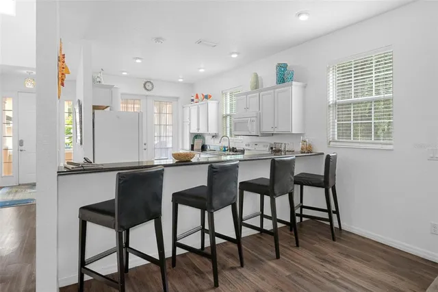 a kitchen with a table chairs sink and cabinets