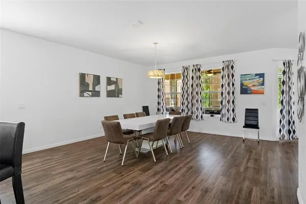 a dining room with furniture and wooden floor