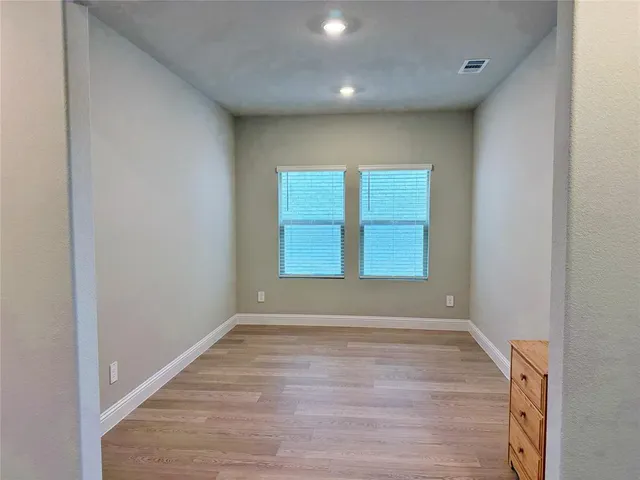 a view of room with window and hardwood floor
