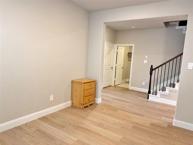 a view of a room with wooden floor and stairs