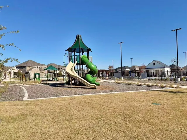 a view of pool with lawn chairs and small yard