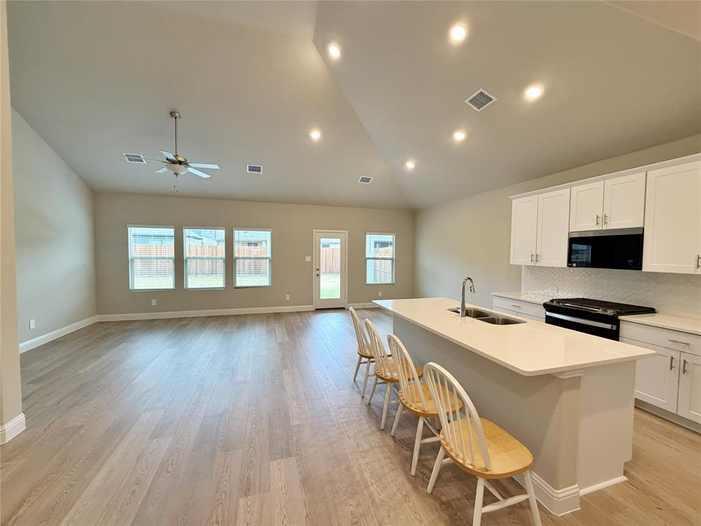 769 Poppy Lane Lavon, TX 75166 - Photo 4 of 32 a view of a dining room with furniture window and wooden floor
