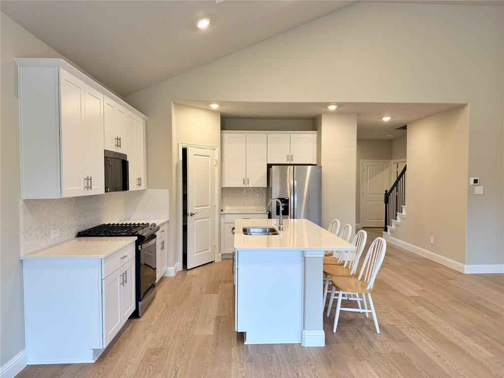 769 Poppy Lane Lavon, TX 75166 - Photo 7 of 32 a large kitchen with a table and chairs in it