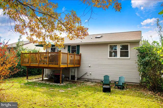 a backyard of a house with barbeque oven table and chairs