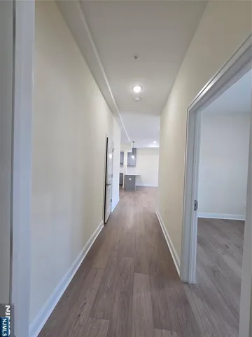 a view of hallway with wooden floor