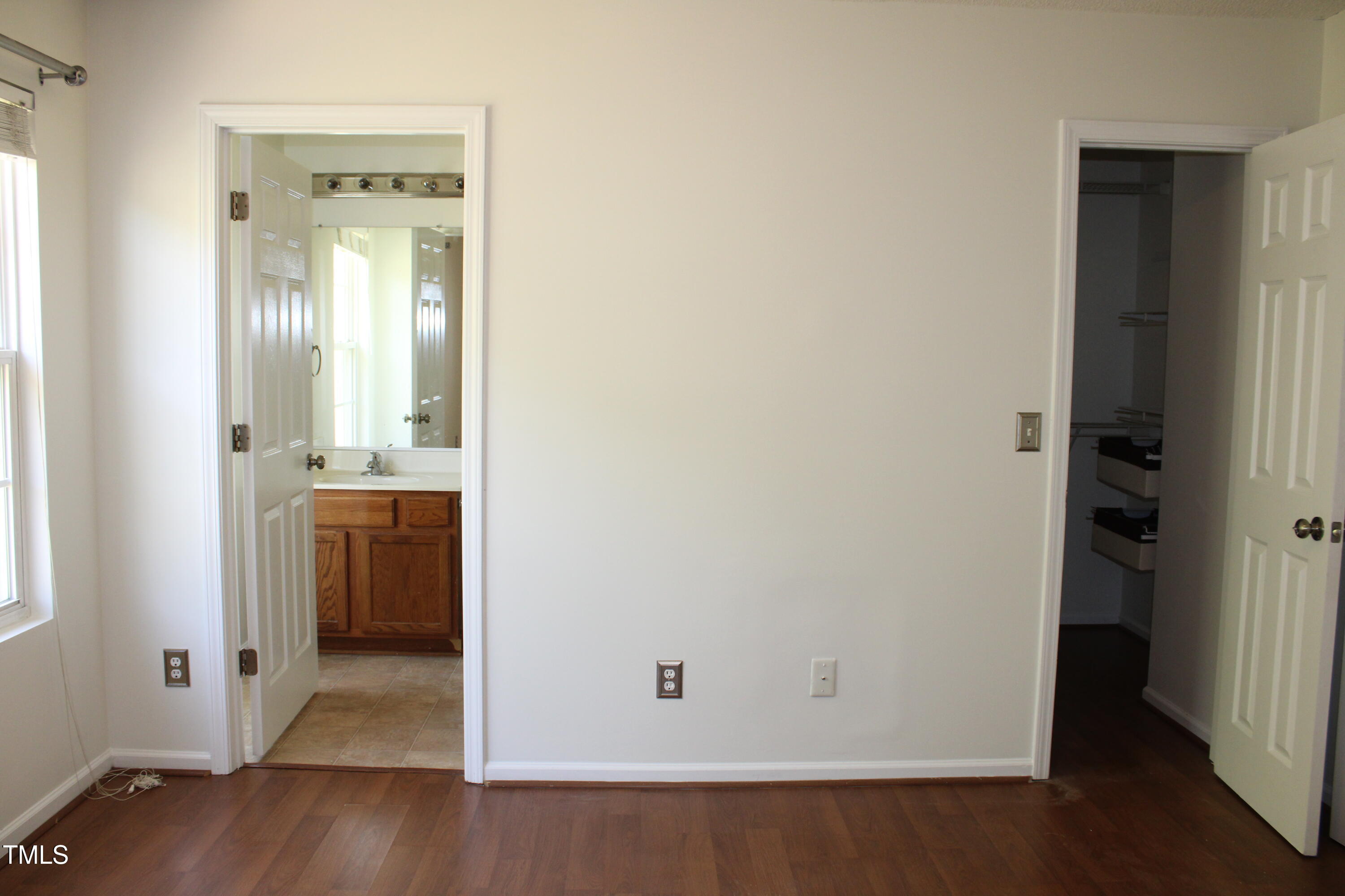 2802 Gross Avenue Wake Forest, NC 27587 - Photo 12 of 20 a view of a hallway with wooden floor and a bathroom