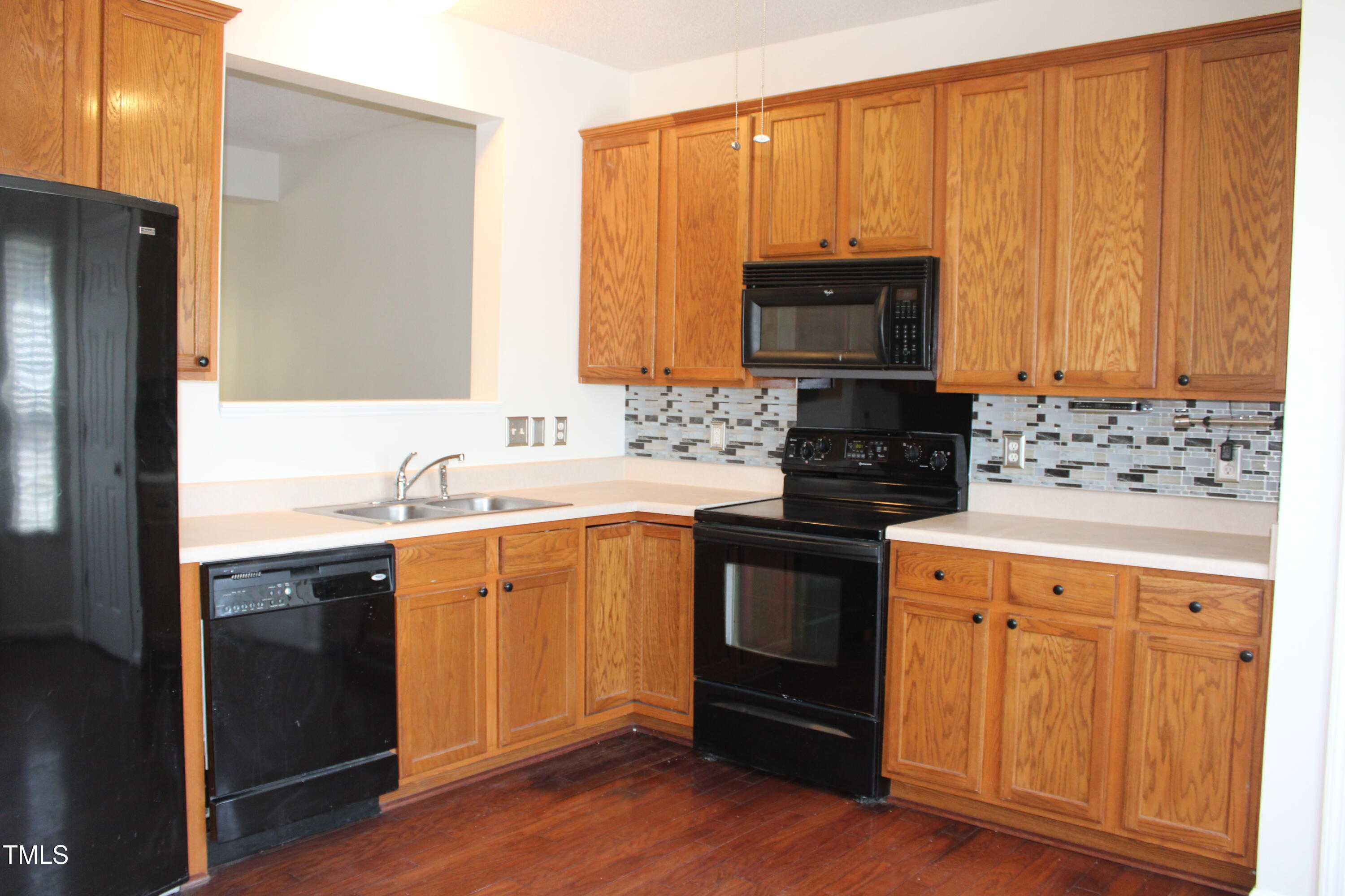 2802 Gross Avenue Wake Forest, NC 27587 - Photo 2 of 20 a kitchen with stainless steel appliances granite countertop a stove a sink and a microwave