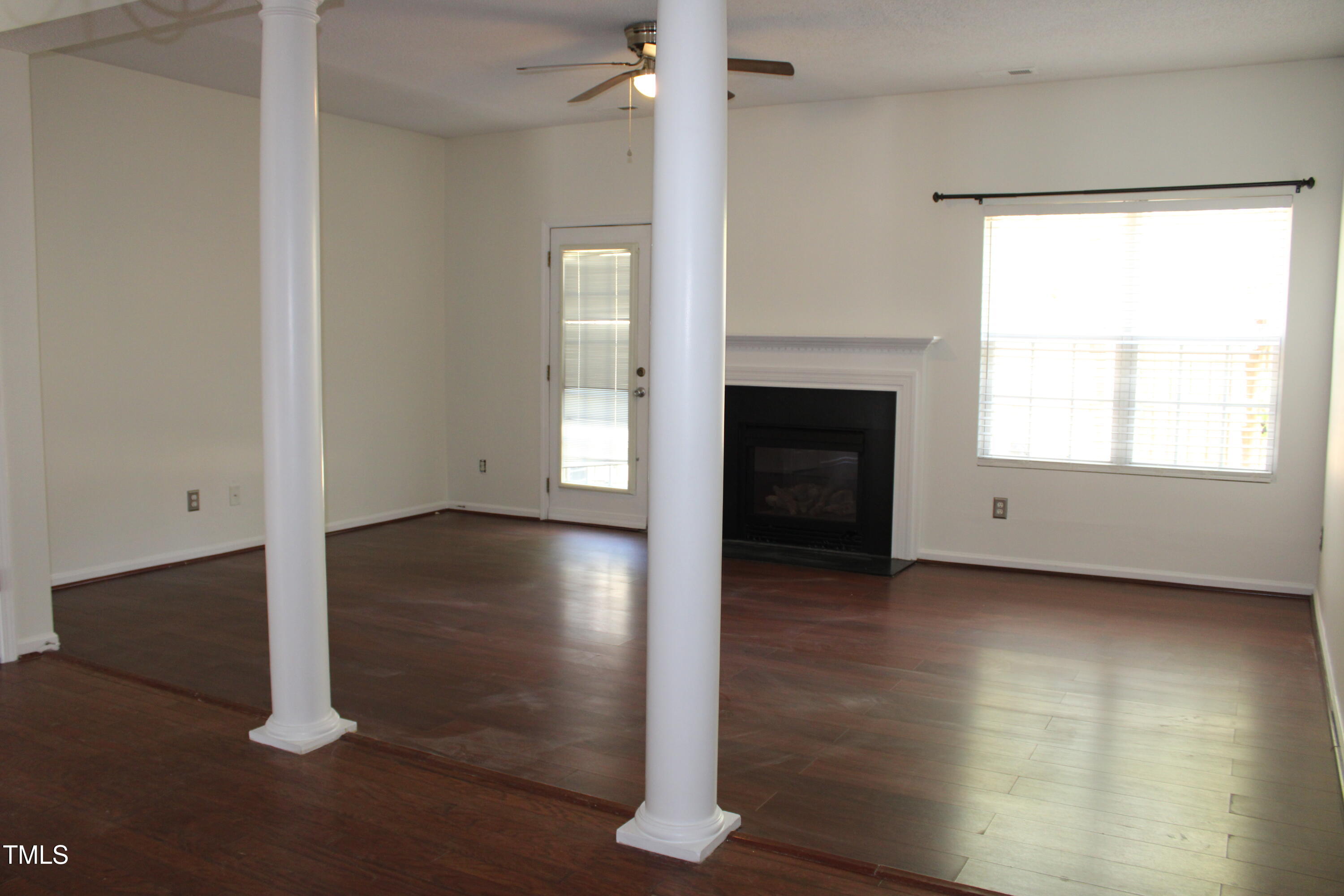 2802 Gross Avenue Wake Forest, NC 27587 - Photo 6 of 20 an empty room with wooden floor fireplace and windows
