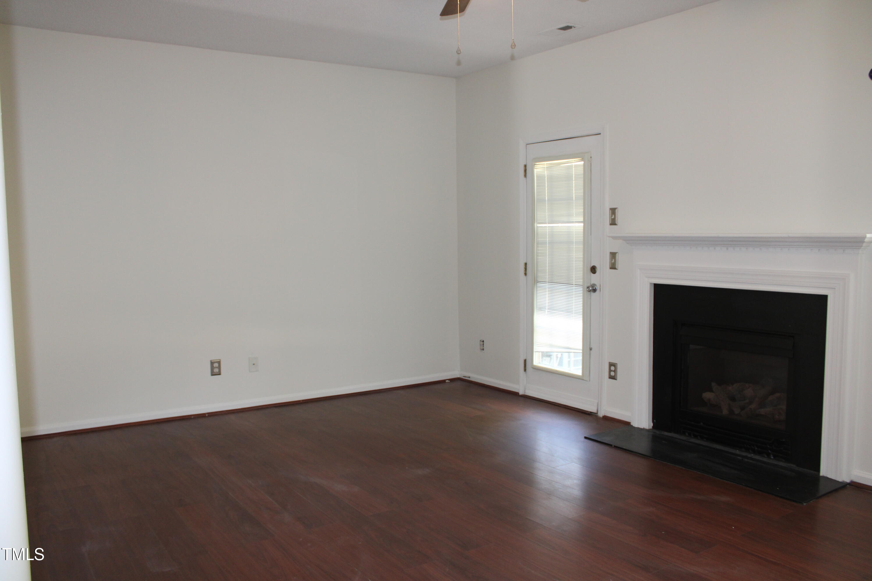 2802 Gross Avenue Wake Forest, NC 27587 - Photo 7 of 20 a view of empty room with wooden floor and fireplace