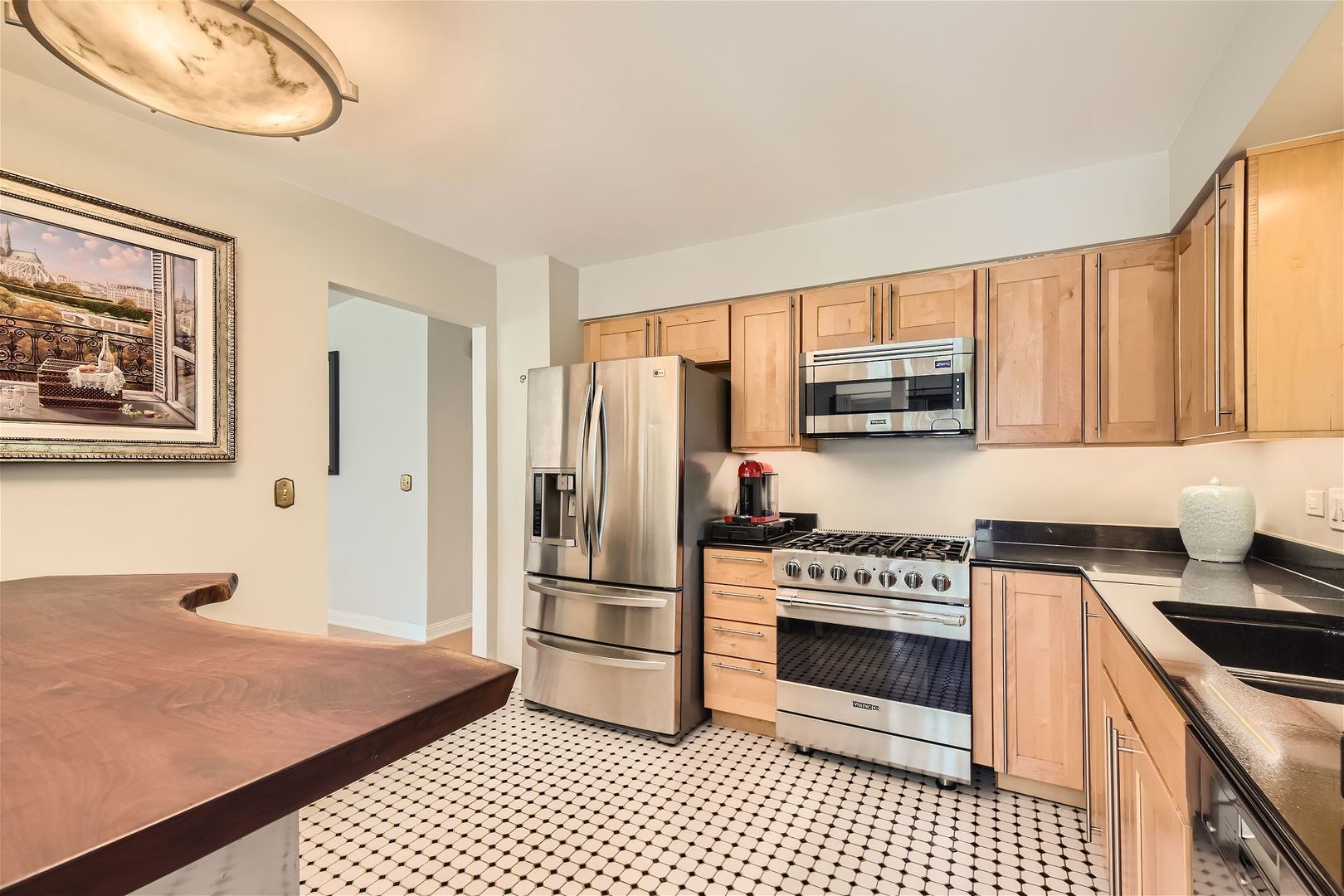 1365 Freeman Road Hoffman Estates, IL 60192 - Photo 11 of 49 a kitchen with granite countertop a refrigerator stove and microwave