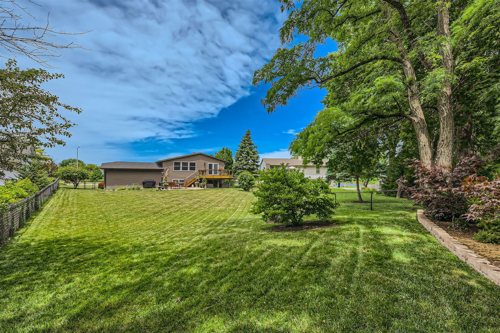 1365 Freeman Road Hoffman Estates, IL 60192 - Photo 34 of 49 a view of a big yard with plants and large trees