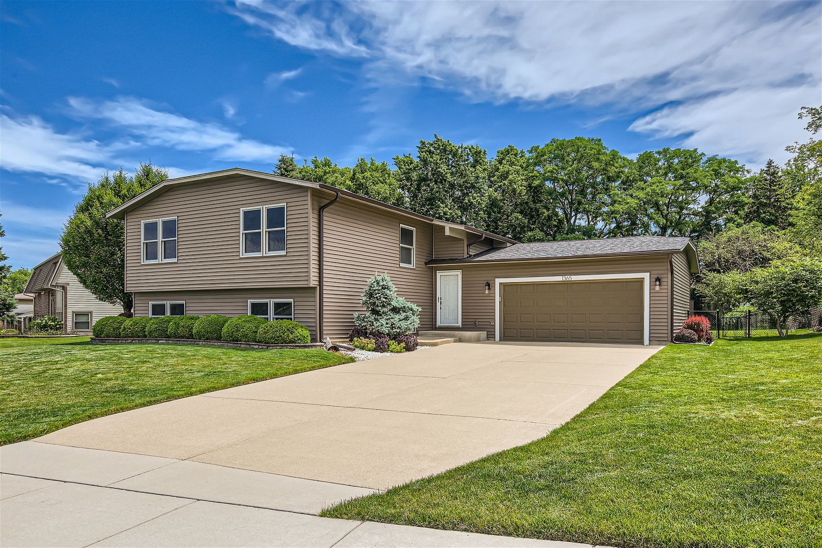 1365 Freeman Road Hoffman Estates, IL 60192 - Photo 36 of 49 a front view of a house with a yard and garage