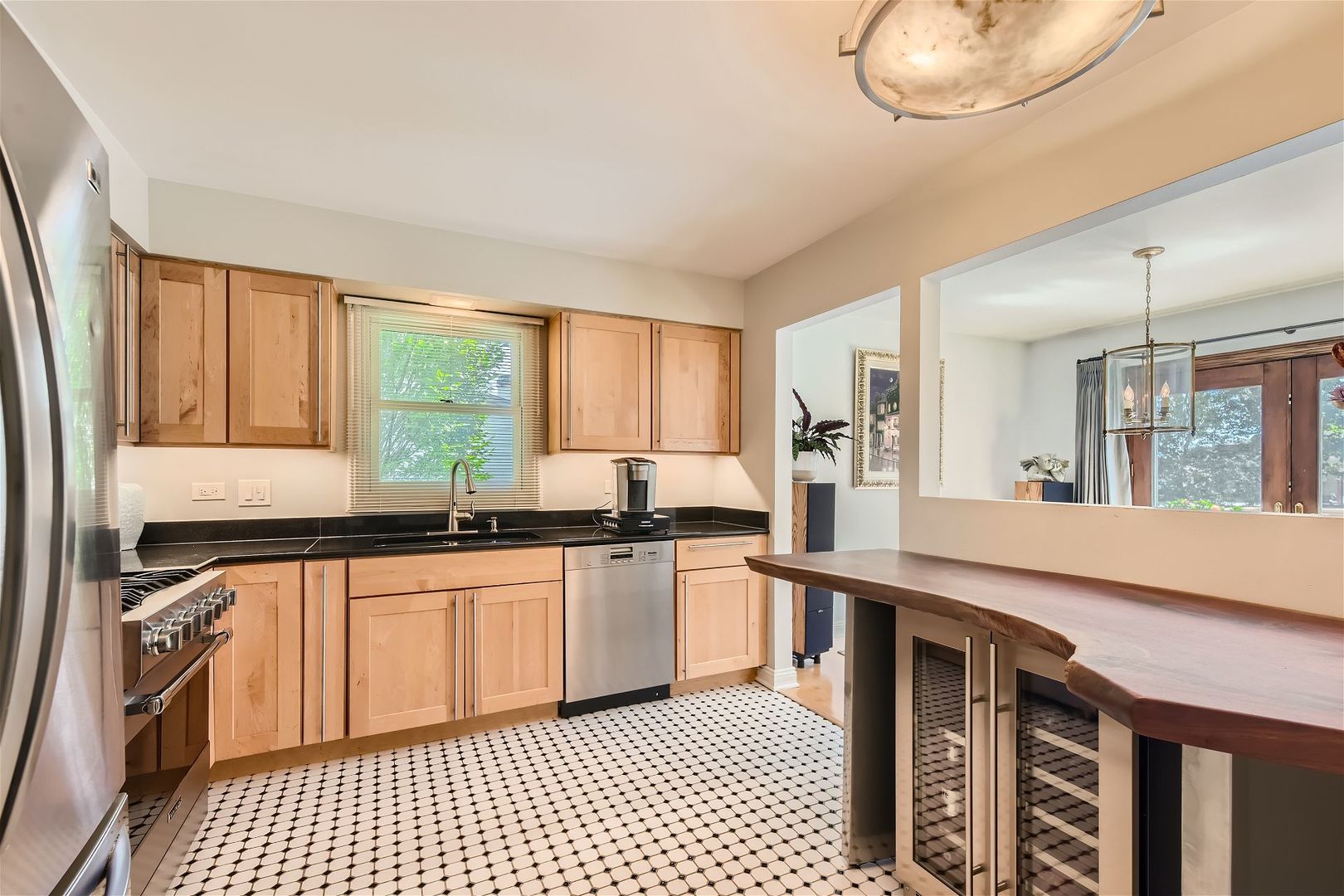 1365 Freeman Road Hoffman Estates, IL 60192 - Photo 10 of 49 a large kitchen with granite countertop a stove and a sink