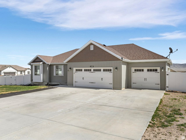 573 South Maxwell Drive Grantsville, UT 84029 - Photo 2 of 25 View of front facade with a gate, driveway, a garage, and a shingled roof